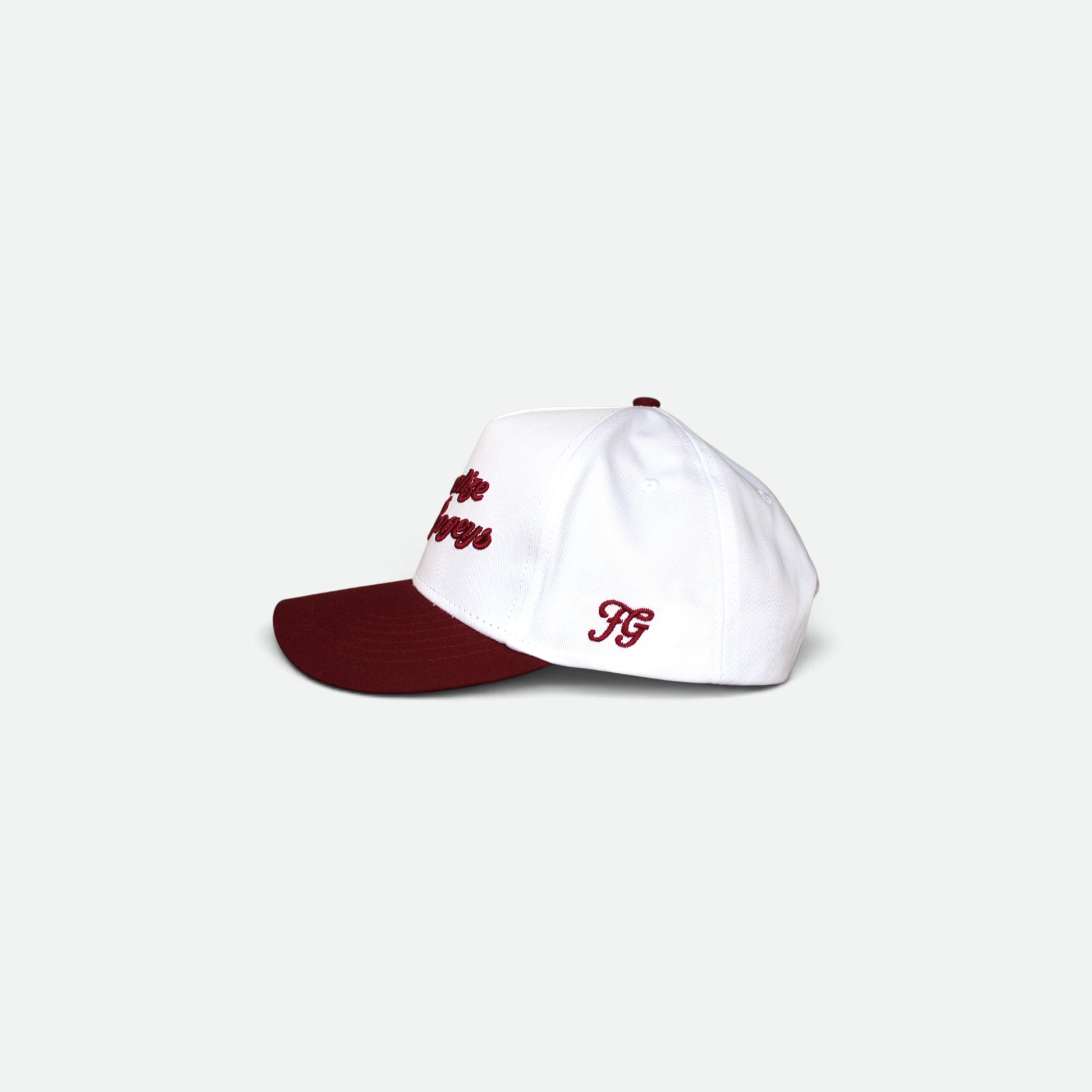 Close-up of a white snapback cap with dark red embroidered text reading 'Normalize Bogeys' on the front panel, with a dark red visor edge visible at the bottom.
