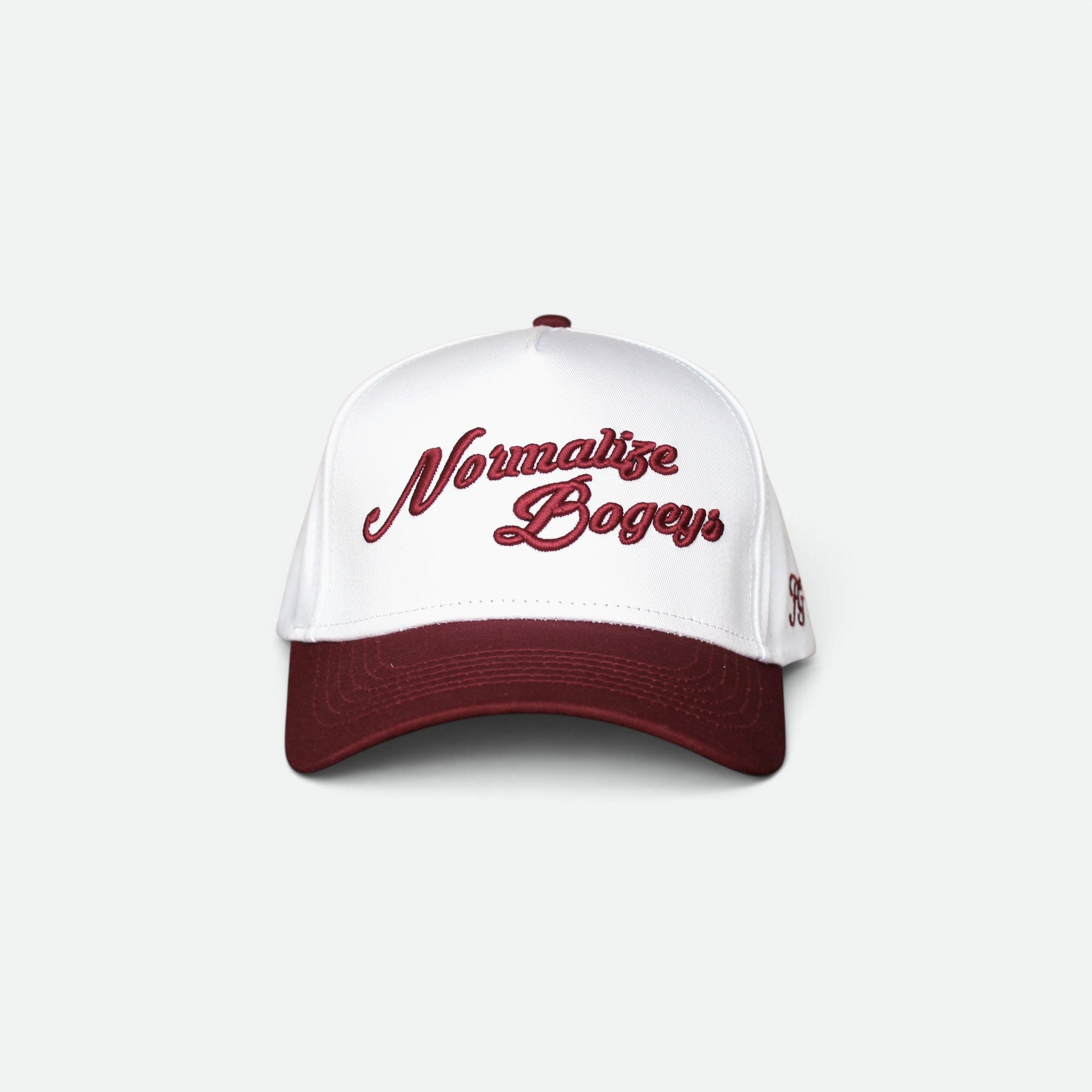 Close-up of a white snapback cap with dark red embroidered text reading 'Normalize Bogeys' on the front panel, with a dark red visor edge visible at the bottom.