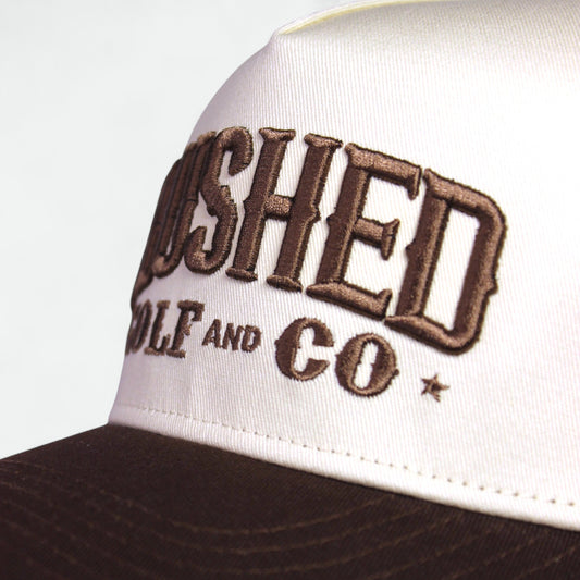 Close-up of embroidered Flushed Golf & Co logo on cotton golf hat
