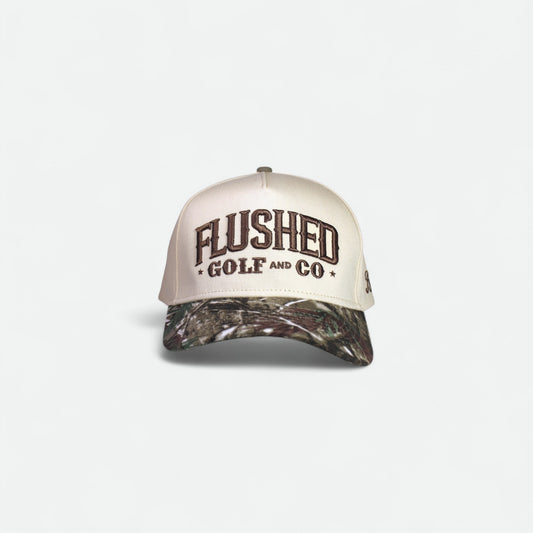 Flushed Golf & Co cotton trucker hat with embroidered logo and camo brim, front view