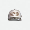 Flushed Golf & Co mesh trucker hat with embroidered logo and camo brim, front view