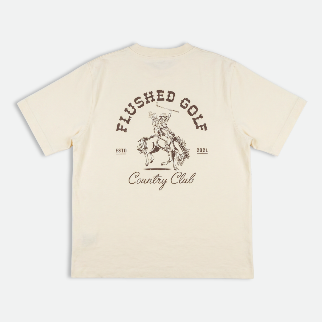 Beige t-shirt with 'Flushed Golf Country Club' text and graphic on a white background