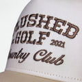 Close-up of Country Club graphic on Flushed Golf trucker hat