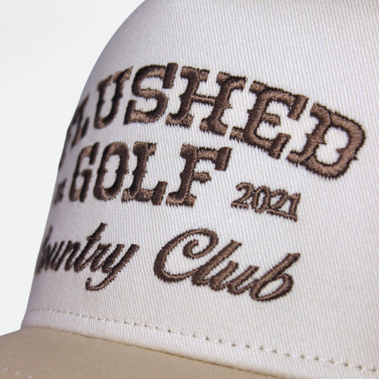 Close-up of Country Club graphic on Flushed Golf trucker hat