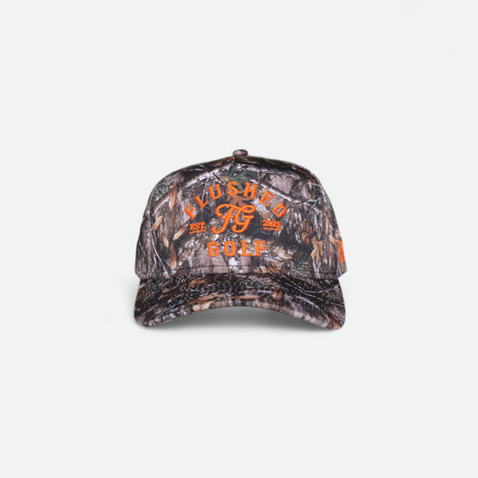 Flushed Golf FG camo golf hat with orange embroidered graphics, front view