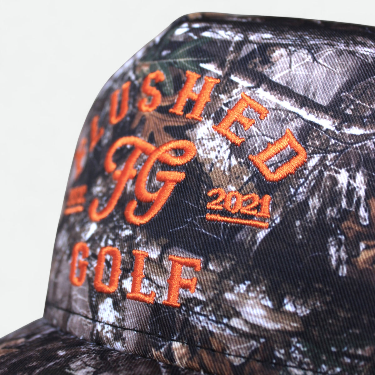 FG camo golf hat with orange embroidery, side view