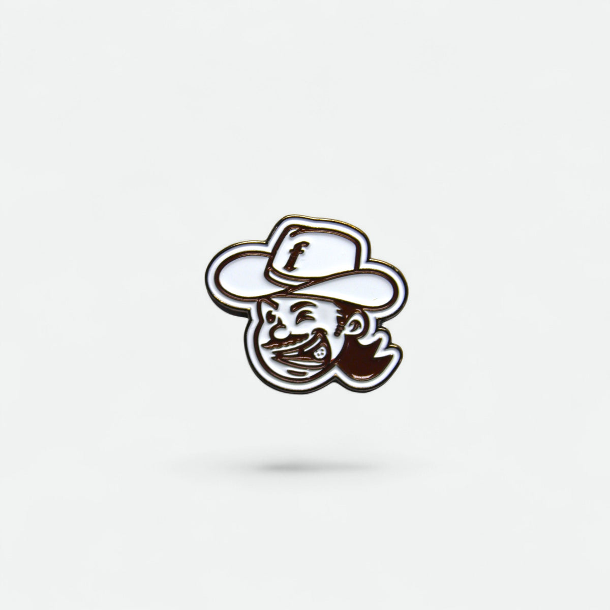 Golf ball marker of flushed golf mascot logo wearing a cowboy hat on a white background