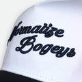 Close-up of Normalize Bogeys embroidery on Flushed Golf hat with navy brim