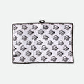 A waffle golf towel with a black border and an all-over repeating flushed golf mascot pattern, shown flat against a light gray background.