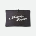 A black textured waffle golf towel with a small black hanging loop at the top and the phrase 'Normalize Bogeys' printed in white script across the centre, shown against a light grey background.