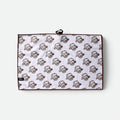 A waffle golf towel with a white background, brown border, and an all-over repeating flushed golf mascot pattern with a black metal clip is attached at the top.