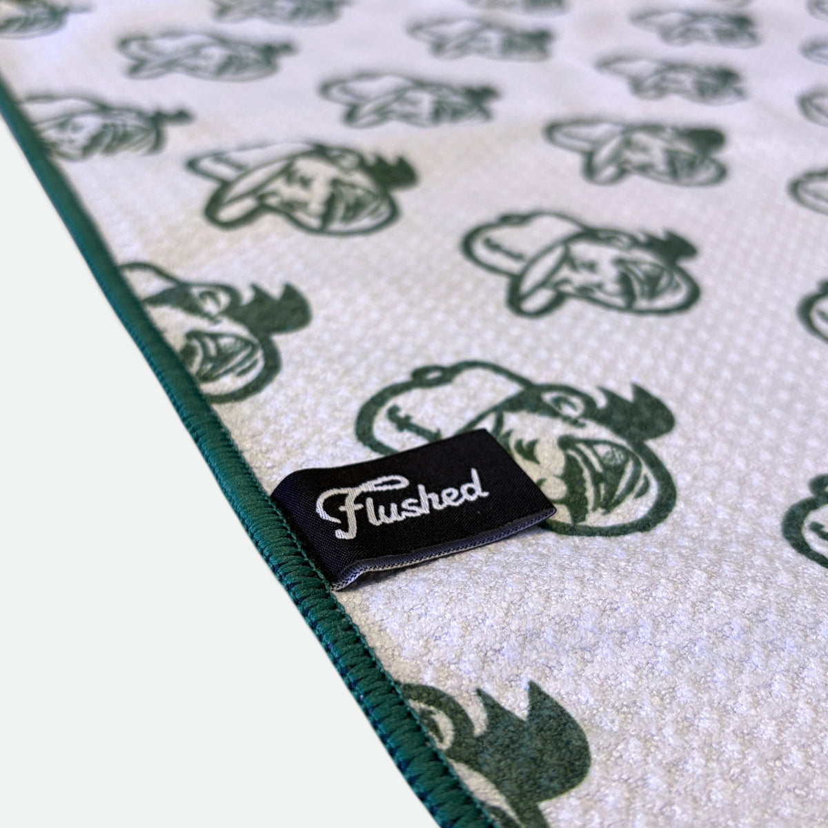 Flushed tag detail on green Normalize Bogeys golf towel